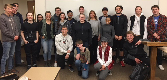 Kristin Goff poses with a group of Whitworth business students.