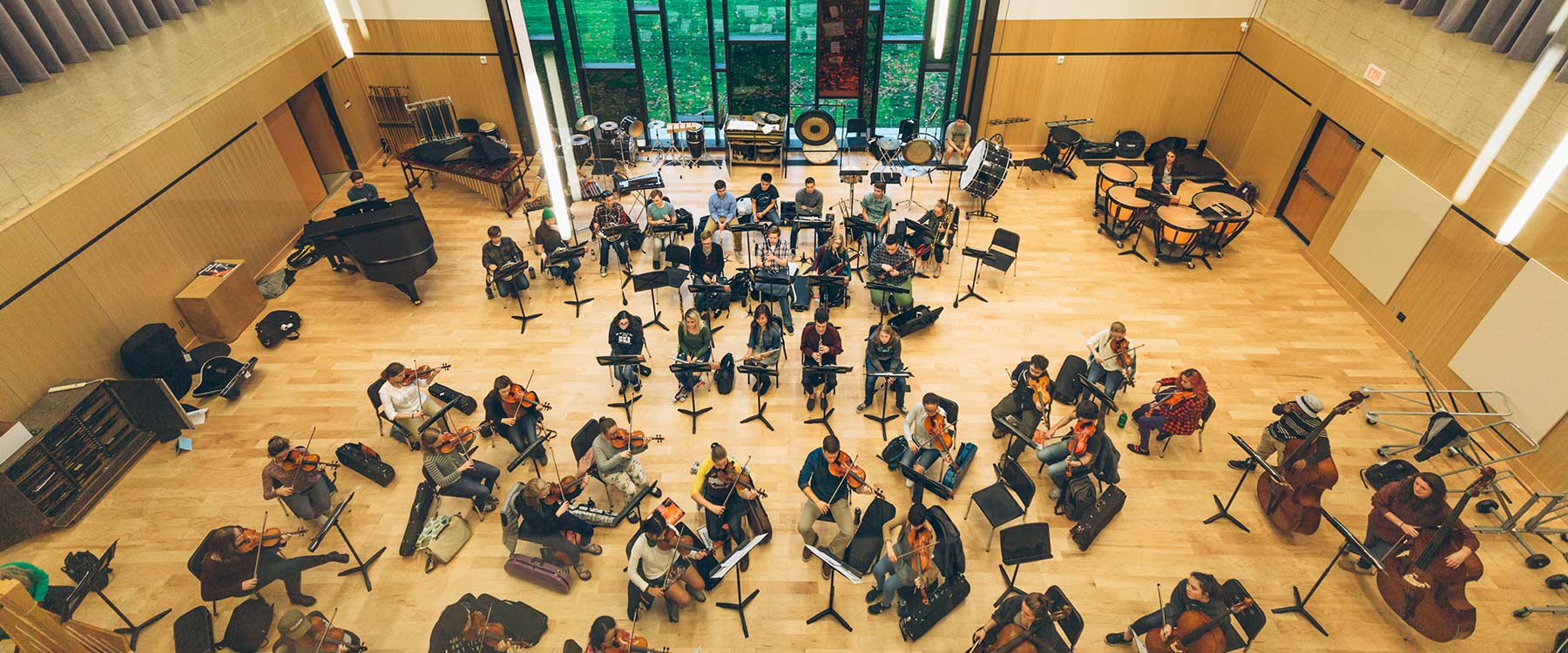 A view from the ceiling looking down at students rehearsing in Cowles Music Center.