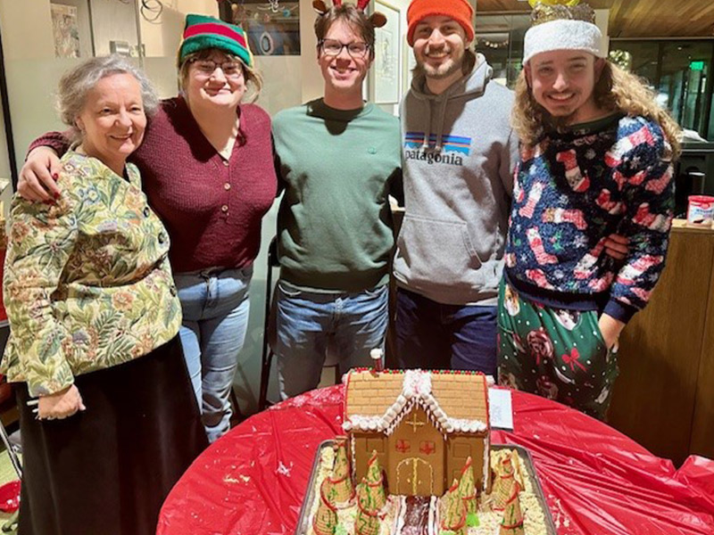 Students building a gingerbread house