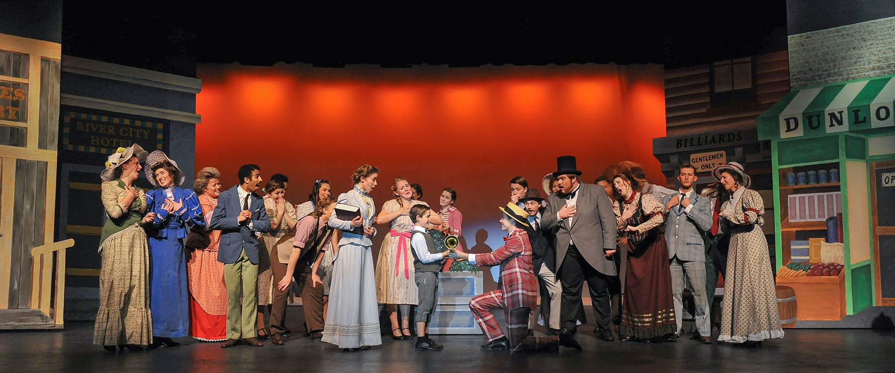 Theatre students gather on stage during a scene of 