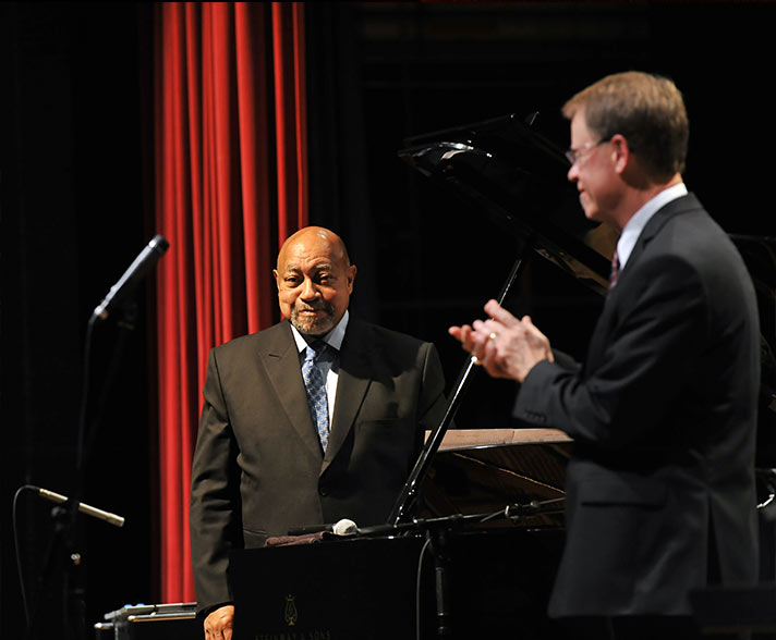 Kenny Barron playing trumpet on stage with other instrumentalists.