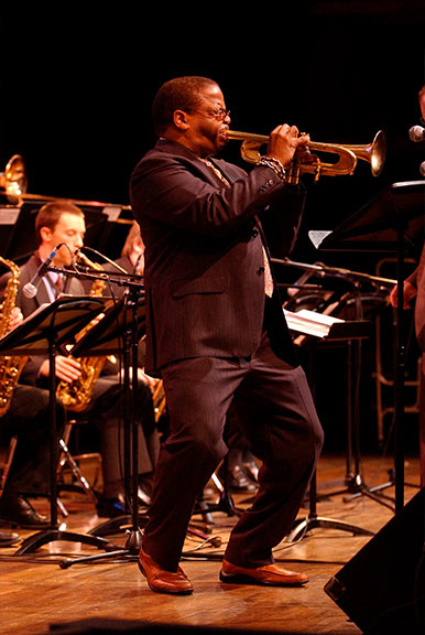 Terence Blanchard playing trumpet on stage with students