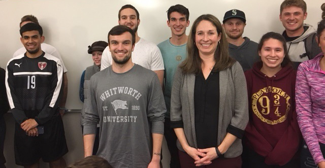 Alisha Benson poses with a group of Whitworth business students.