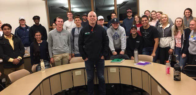 Jeff Adem poses with a group of Whitworth business students.
