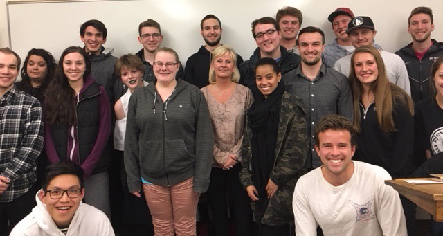 Marty Dickinson poses with a group of Whitworth business students.