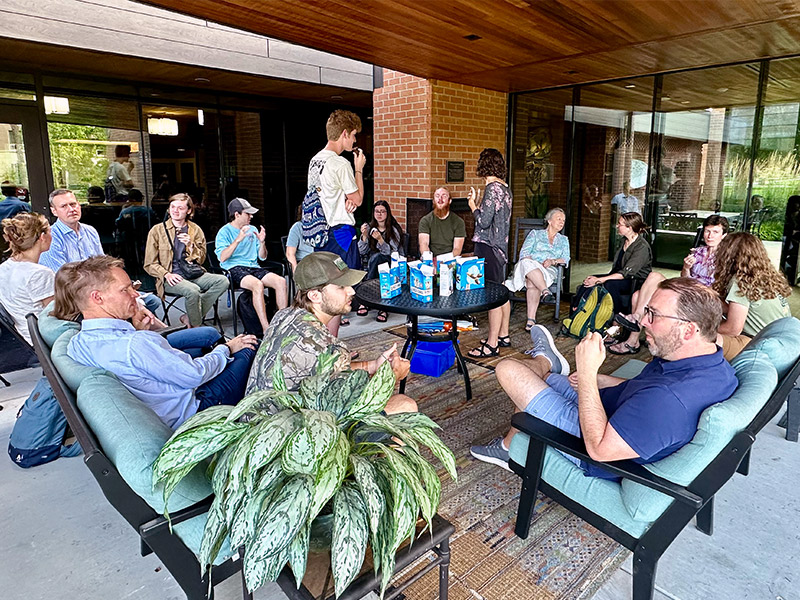 Students gathered around a table eating ice cream.