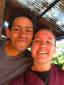 Two young adults pose for a close-up photo outdoors.