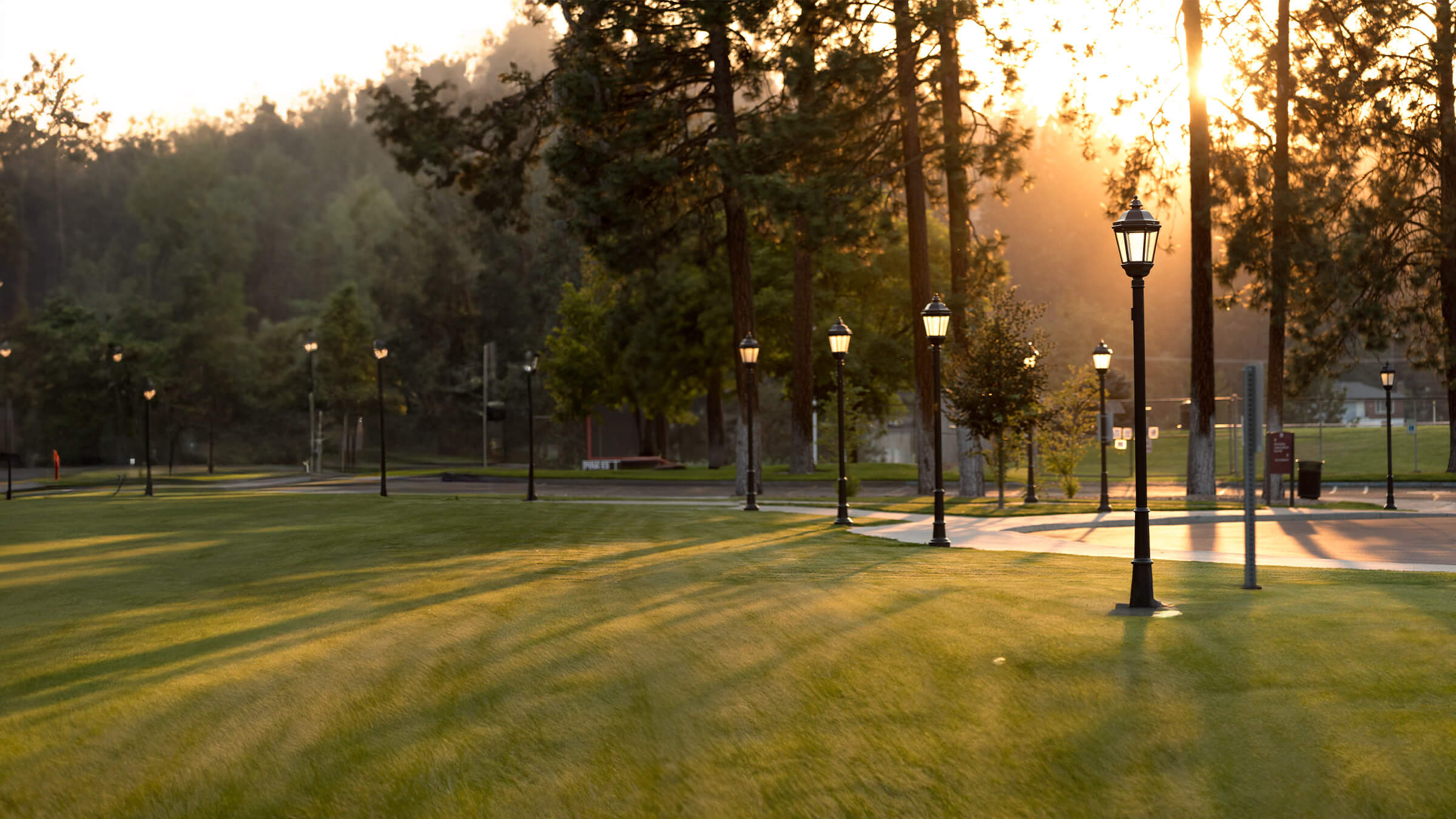 Campus with path lights on in early morning