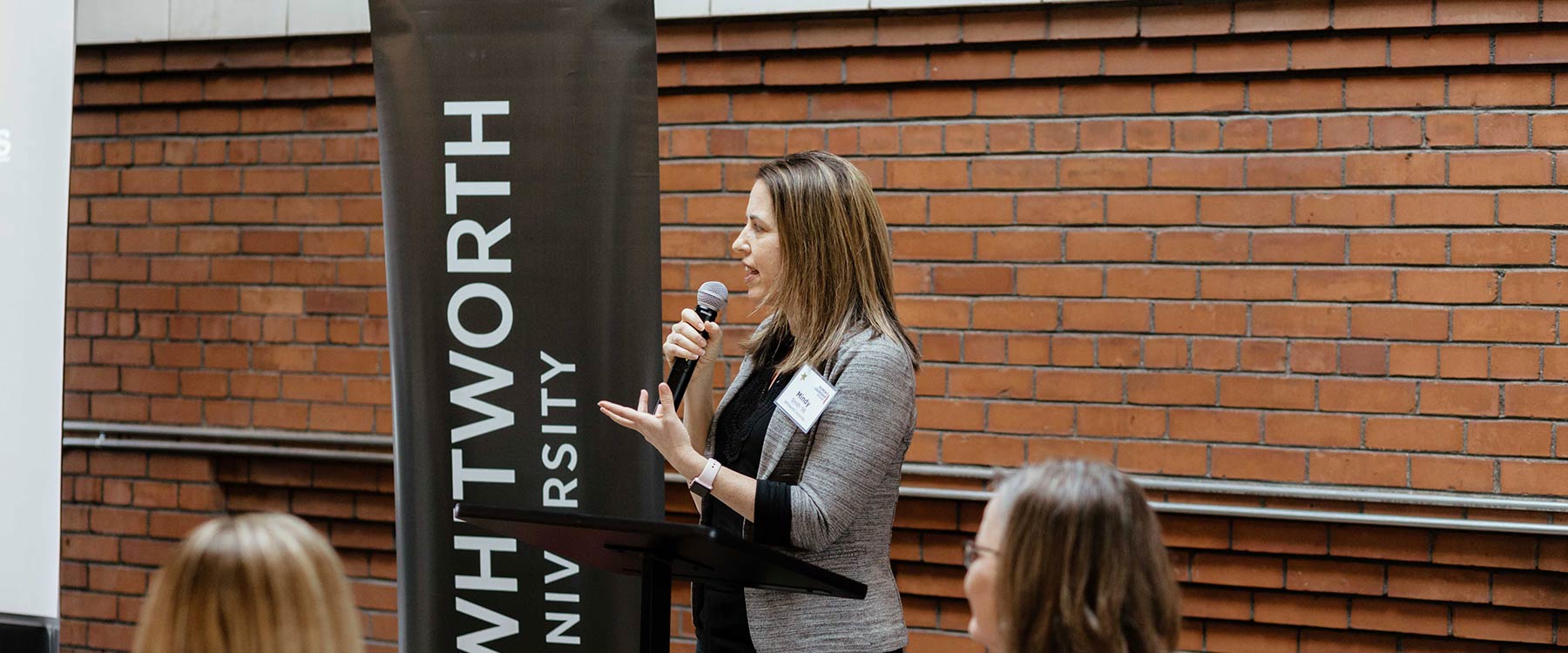 Rev. Mindy Smith speaks at a podium with a microphone.