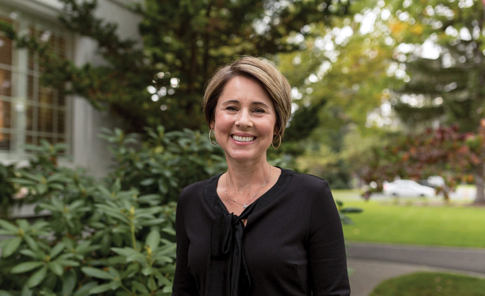 Julie Taylor smiles while standing outside on campus