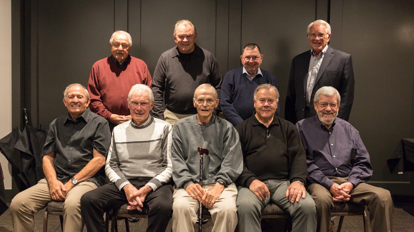 The 1960 Whitworth National Championship team reunion gather together and smile