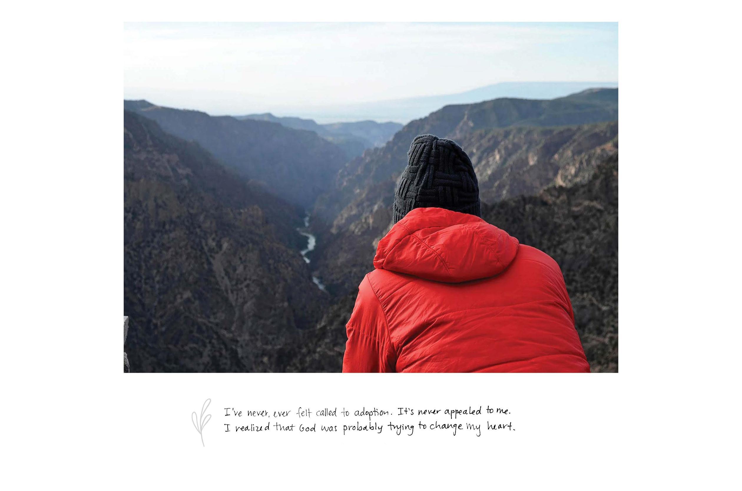 Person in a red jacket and black beanie overlooks a canyon with winding river; handwritten text below.