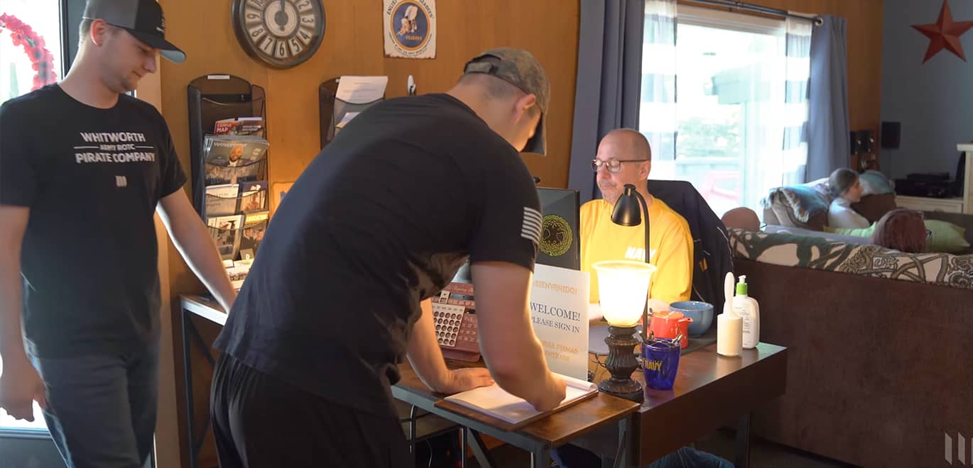 Military students sign in at a desk in the military and veterans resource center.
