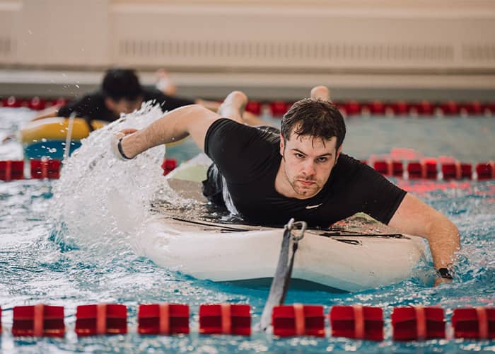 Swimming student works out in a pool.