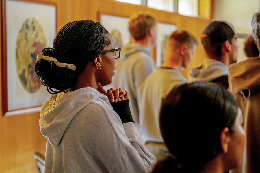 Students sing and pray in a chapel setting.